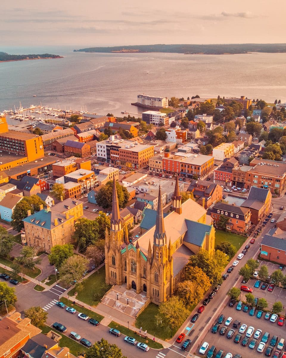 an aerial view of a city with a lake in the background